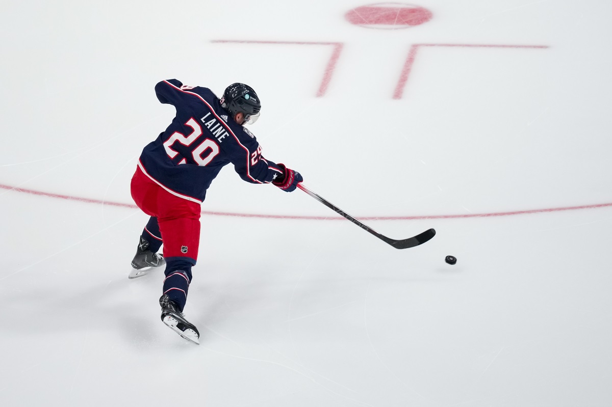 Kirill Marchenko of the Columbus Blue Jackets attempts to clear