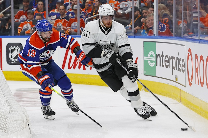 Los Angeles Kings forward Pierre-Luc Dubois (80) protects the puck from Edmonton Oilers forward Adam Henrique (19) during the second period in game five of the first round of the 2024 Stanley Cup Playoffs at Rogers Place.