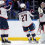 Columbus Blue Jackets goaltender Elvis Merzlikins (90) celebrates with centers Zachary Aston-Reese (27) and Sean Monahan (23) after defeating the New York Islanders in a shootout at UBS Arena.