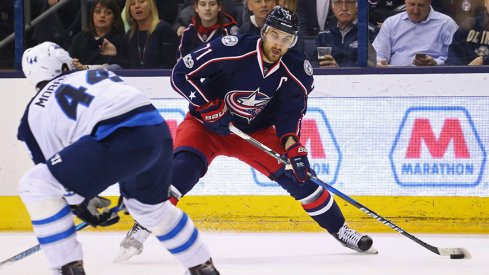 Columbus Blue Jackets left wing Nick Foligno skates with the puck against Winnipeg Jets defenseman Josh Morrissey.