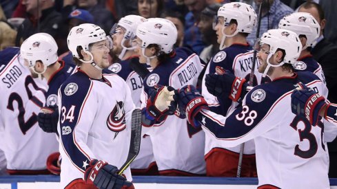 Columbus Blue Jackets right wing Josh Anderson (34) celebrates his short-handed goal with center Boone Jenner (38) against the Toronto Maple Leafs at Air Canada Centre. The Blue Jackets beat the Maple Leafs 3-2. 