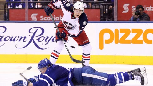 Sonny Milano tries to saucer a pass over a Leafs defenseman