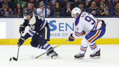 Oilers' forward Connor McDavid works hard to track down Blue Jackets' forward Brandon Saad