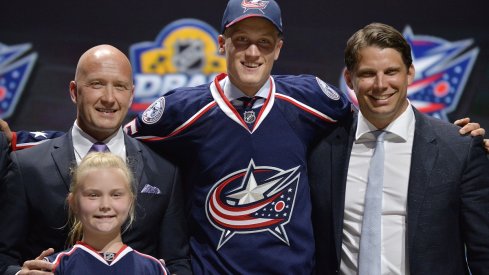 Gabriel Carlsson poses with team officials after being selected 29th overall in the 2015 NHL Draft.