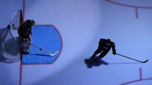 Sergei Bobrovsky and Cam Atkinson skate around in anticipation of a game to start