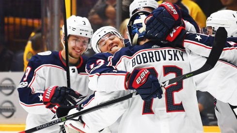 Cam Atkinson hugs Sergei Bobrovsky