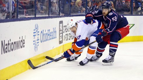 David Savard tries to push Anders Lee off of the puck at Nationwide Arena