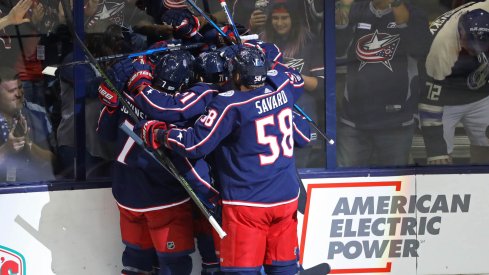 Sonny Milano celebrates his first goal with his teammates. 