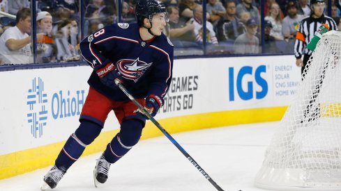 Zach Werenski carries the puck up the ice 