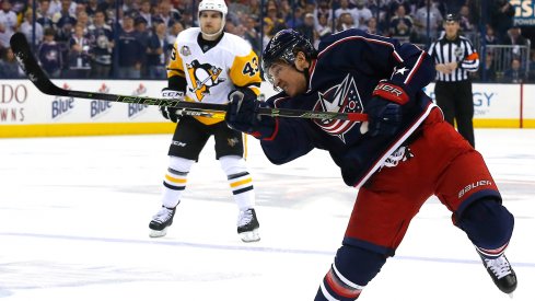 Cam Atkinson shoots a puck versus the Pittsburgh Penguins at Nationwide Arena