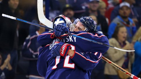 Sergei Bobrovsky and Nick Foligno hug following a win. 