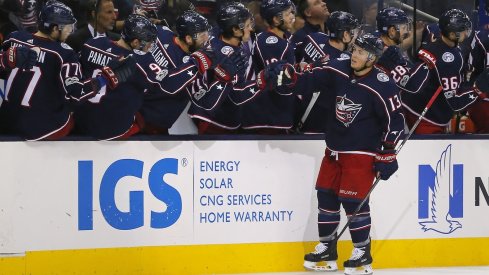 Cam Atkinson swings by the bench after scoring a goal