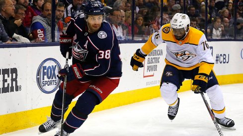 Boone Jenner skates past P.K. Subban of the Nashville Predators at Nationwide Arena.