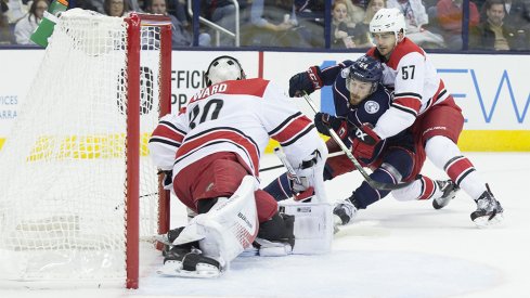 Oliver Bjorkstrand gets checked against the Carolina Hurricanes 