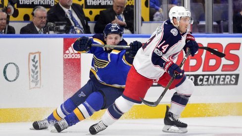 Jordan Schroeder gets tracked down by a St. Louis Blues player during the preseason