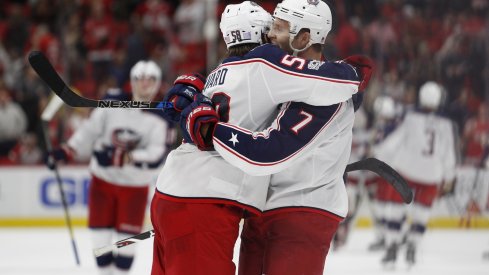 Jack Johnson and David Savard celebrate after Johnson scores the game-winning goal