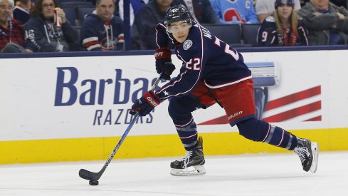 Sonny Milano skating down the ice looking for an open player