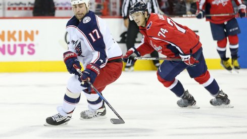 Brandon Dubinsky skates up the ice as John Carlson works to take away the puck