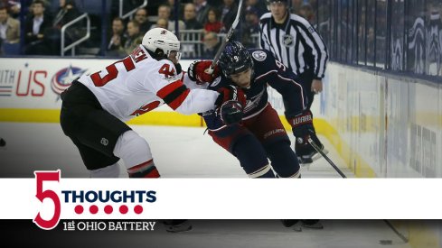 Artemi Panarin tries to get by a member of the New Jersey Devils