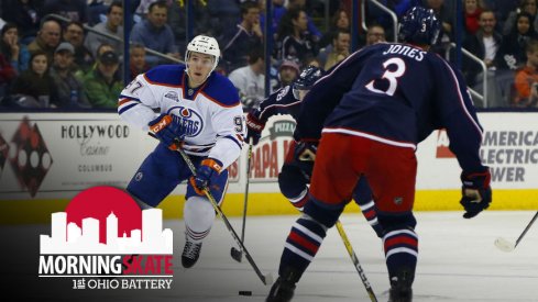 Connor McDavid skates the puck up the ice against Seth Jones