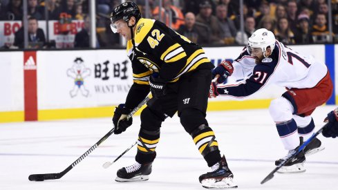 Blue Jackets forward Nick Foligno chases down Bruins forward David Backes