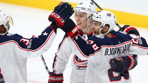 Oliver Bjorkstrand celebrates a goal with Matt Calvert and Seth Jones.