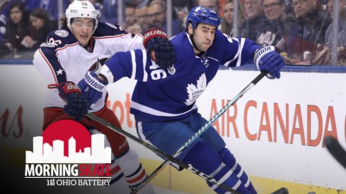 Sonny Milano tries to fight for the puck against Maple Leafs defenseman Roman Polak