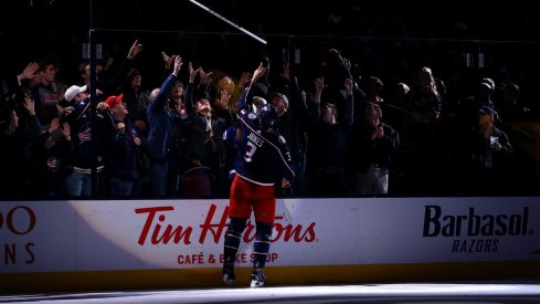 Seth Jones gives away a stick after being named a star after the game