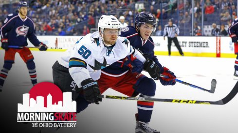 Zach Werenski tries to fight Sharks Chris Tierney off of the puck