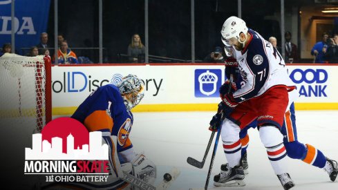 Nick Foligno tries to sneak the puck past Thomas Greiss