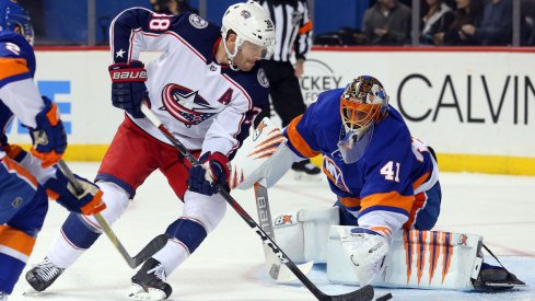 Boone Jenner tries to beat Islanders goaltender Jaroslav Halak