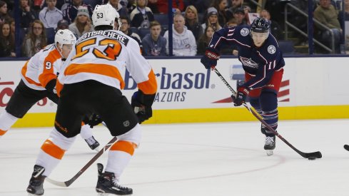 Matt Calvert gets a shot off between a couple of Philadelphia Flyers