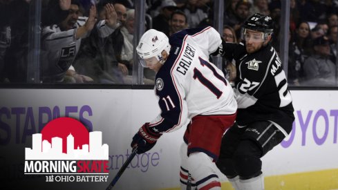 Matt Calvert tries to keep the puck away from Kings defenseman Alec Martinez