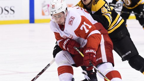 Dylan Larkin carries the puck against the Boston Bruins