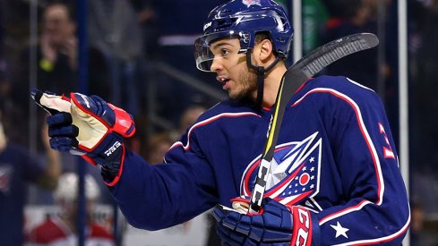 Seth Jones of the Columbus Blue Jackets points at someone who's not as good at hockey as he is. 