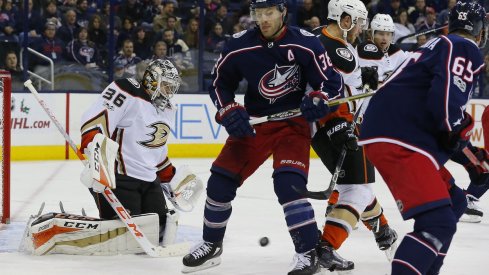 Anaheim Ducks goaltender John Gibson attempts to stop a puck against the Columbus Blue Jackets