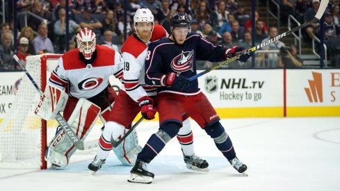 Columbus Blue Jackets center Pierre-Luc Dubois fights for position in front of the Carolina Hurricanes net at Nationwide Arena.