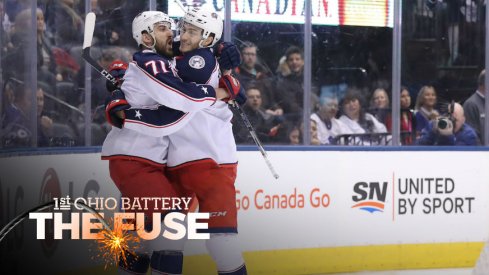 Columbus Blue Jackets captain Nick Foligno and center Alexander Wennberg celebrate a goal scored against the Toronto Maple Leafs.