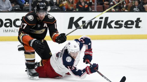 Columbus Blue Jackets' forward Cam Atkinson gets tripped up fighting for a puck on Sunday night against the Anaheim Ducks.