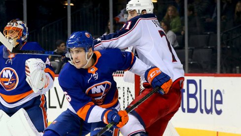 Nick Foligno battles in front of the net with Islanders defender Ryan Pulock