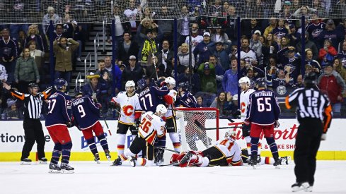 Mike Smith of the Calgary Flames makes a big save against the Blue Jackets.