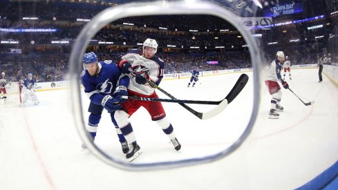 Pierre-Luc Dubois fights for a puck with Dan Girardi at Amalie Arena in Tampa Bay, Florida.