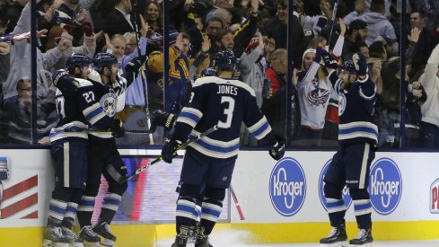 Ryan Murray Seth Jones and Nick Foligno celebrate with Boone Jenner after scoring against the Nashville Predators