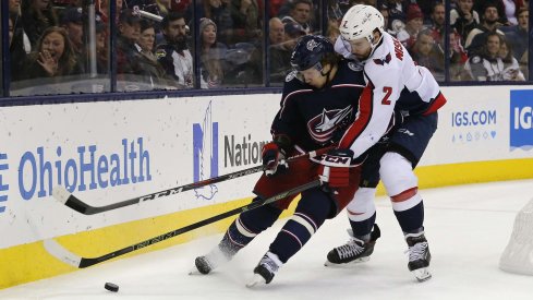 Artemi Panarin battles for position with Matt Niskanen