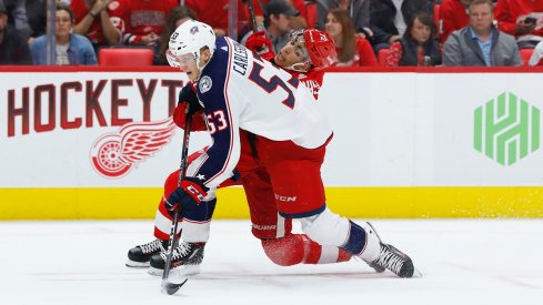 Gabriel Carlsson fights for a puck in the second period of his only NHL game this season at Little Caesars Arena