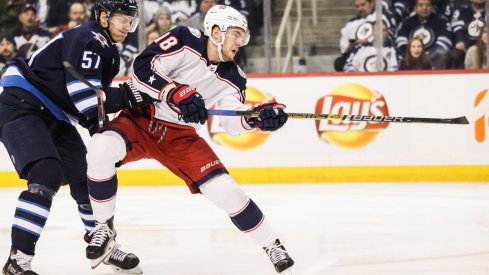 Pierre-Luc Dubois fights off the check of Winnipeg Jets defenseman Tyler Myers 