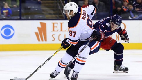 Scott Harrington struggles to contain Connor McDavid in Saturday's game for the Columbus Blue Jackets against the Edmonton Oilers