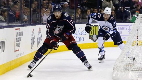 Josh Anderson skates away from Winnipeg Jet Patrik Laine during a home matchup at Nationwide Arena.