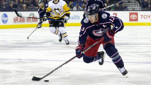 Cam Atkinson skates down the ice with the puck against the Pittsburgh Penguins at Nationwide Arena