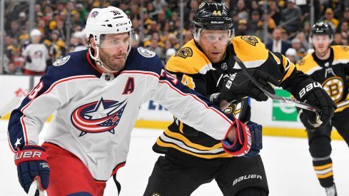 Columbus Blue Jackets center Boone Jenner fights for the puck against the Boston Bruins during a game at TD Garden.